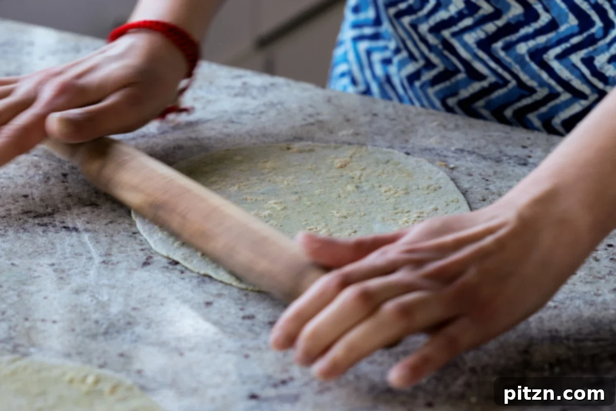 Yeast-Free Spinach Paratha Flatbread 33 The stuffed paratha after being fully rolled out, showing an even distribution of filling.