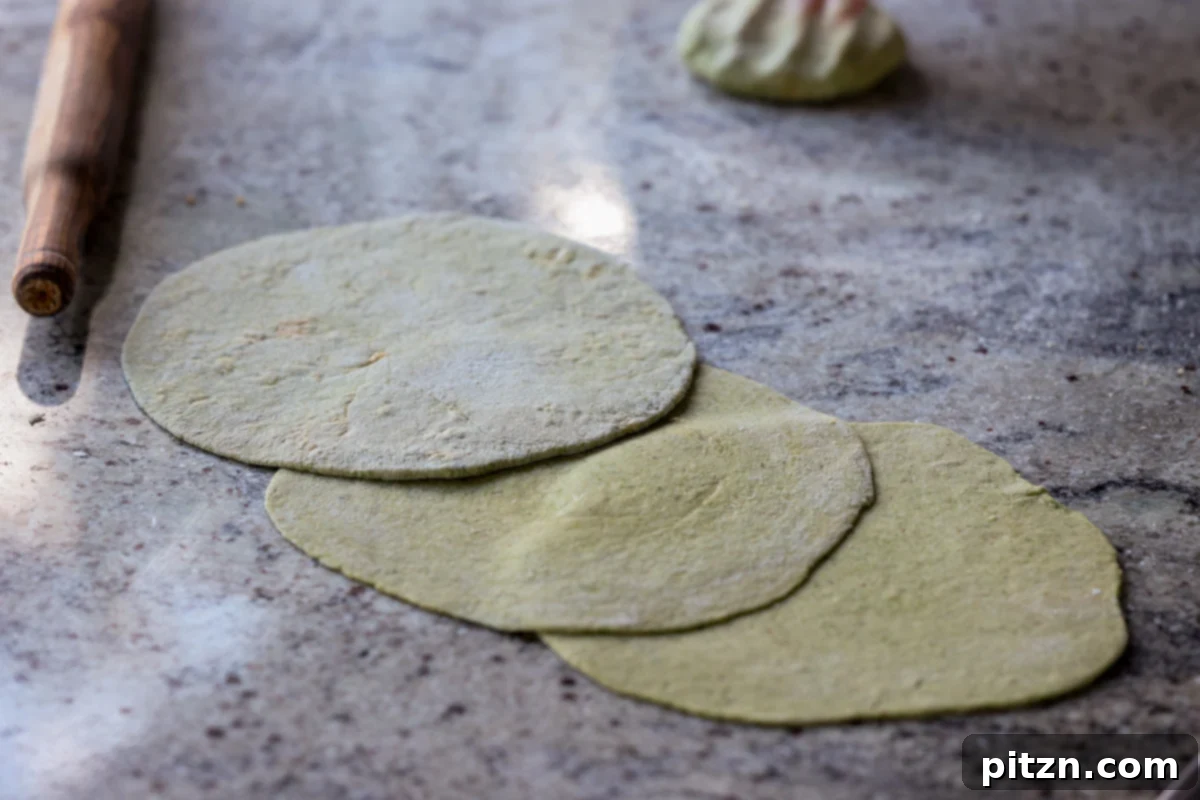 Yeast-Free Spinach Paratha Flatbread 34 A freshly rolled out spinach paratha resting on a clean counter, awaiting its turn on the hot skillet.