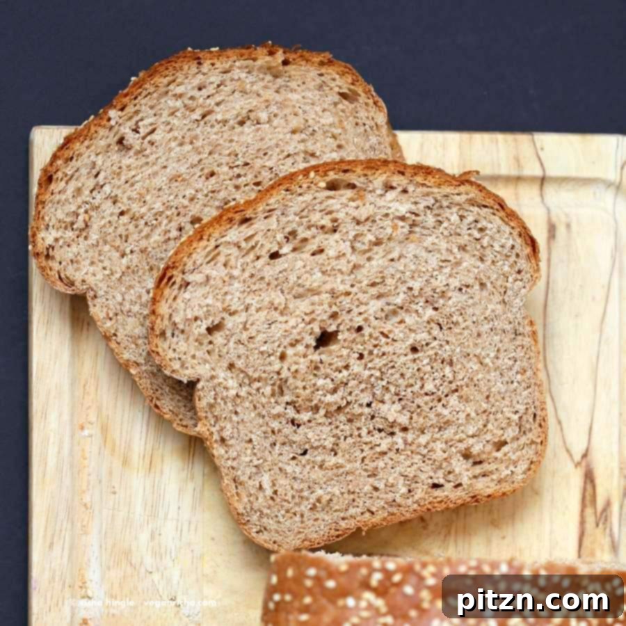 Homemade 100% Whole Wheat Bread 4 Three slices of 100% Whole Wheat Bread stacked, showcasing the golden crust and soft interior