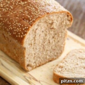 A golden brown loaf of 100% Whole Wheat Bread