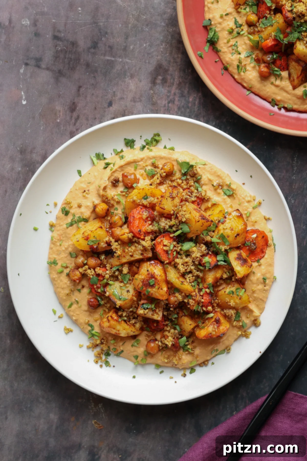 Harissa bean puree topped with roasted vegetables and baharat walnuts