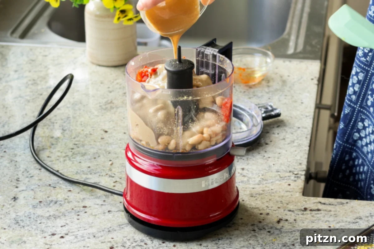 Adding bean puree ingredients to the food processor