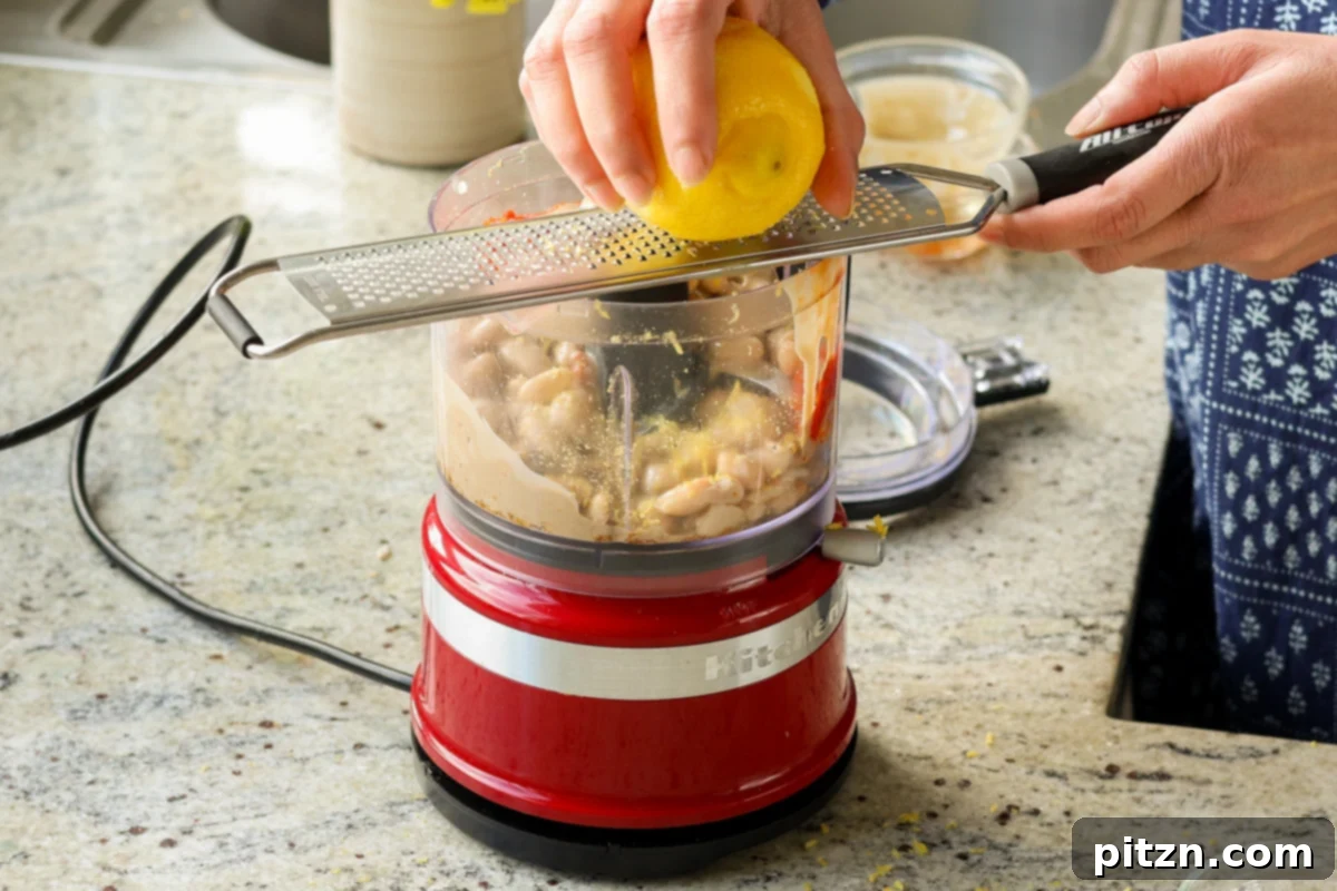 Adding lemon zest to the bean mixture
