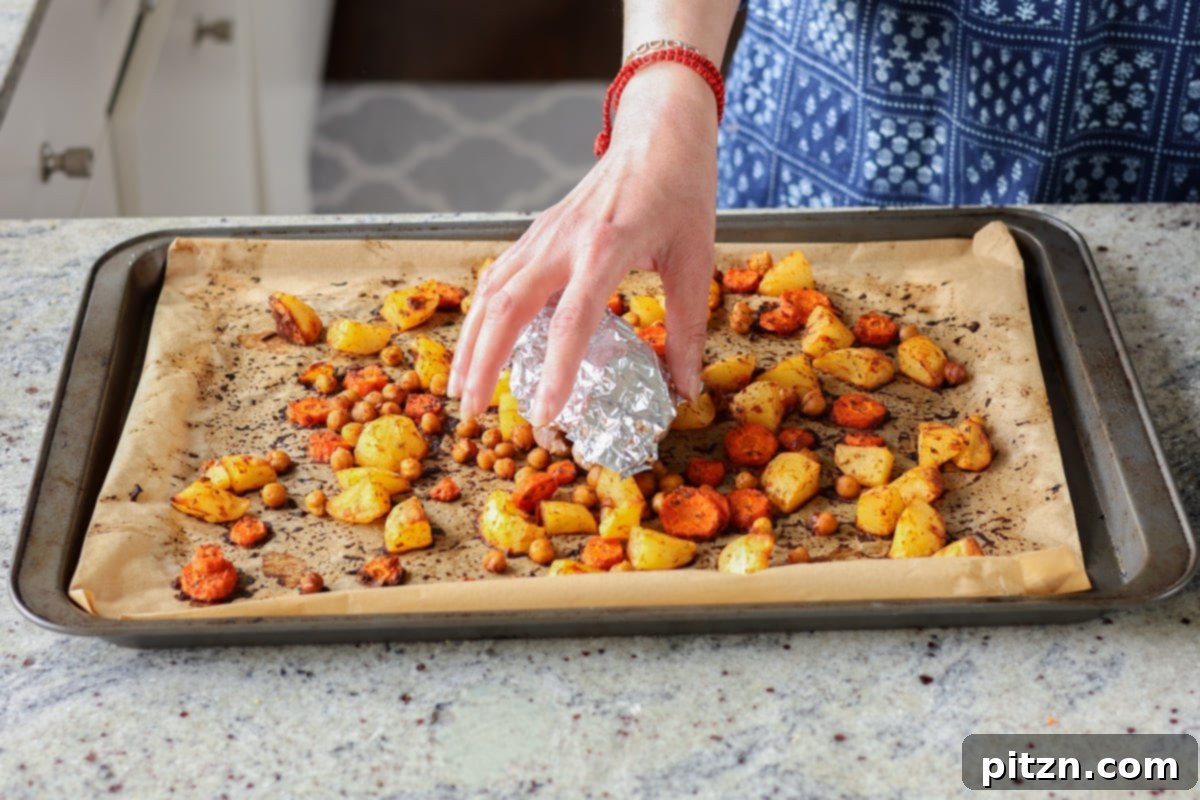 Removing roasted garlic from the baking sheet