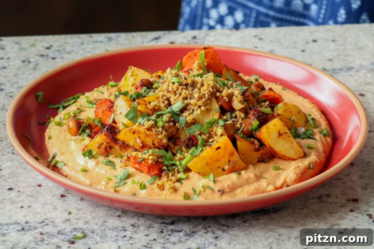 Harissa bean puree topped with roasted vegetables and baharat walnuts
