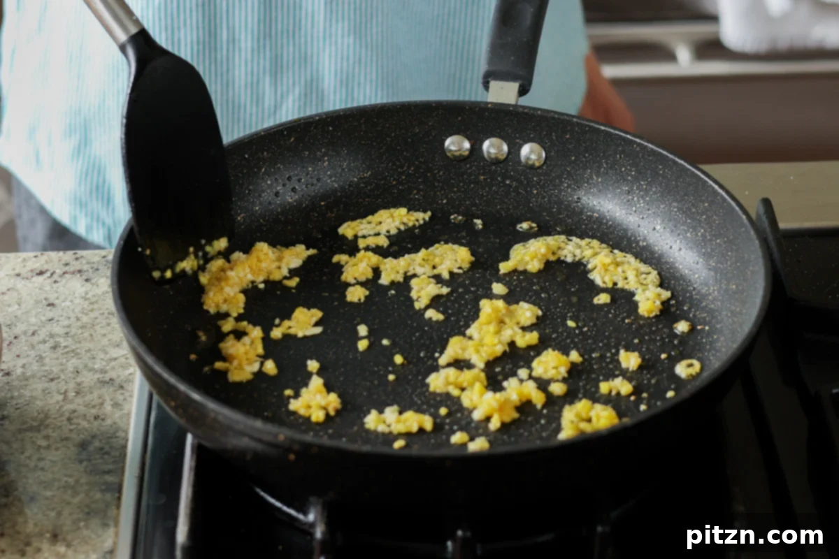 adding ginger and garlic to the pan