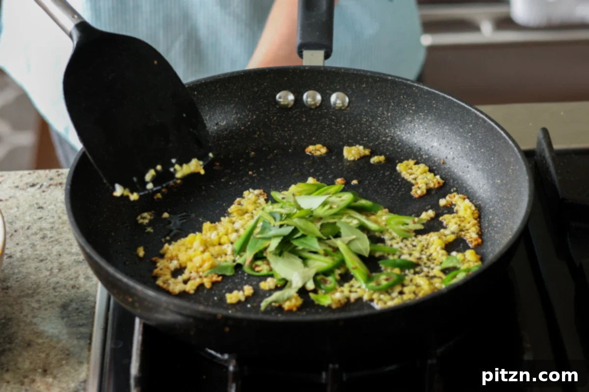 adding curry leaves to the pan