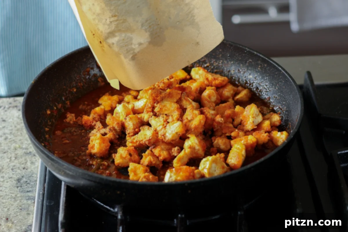 adding tofu to the sauce