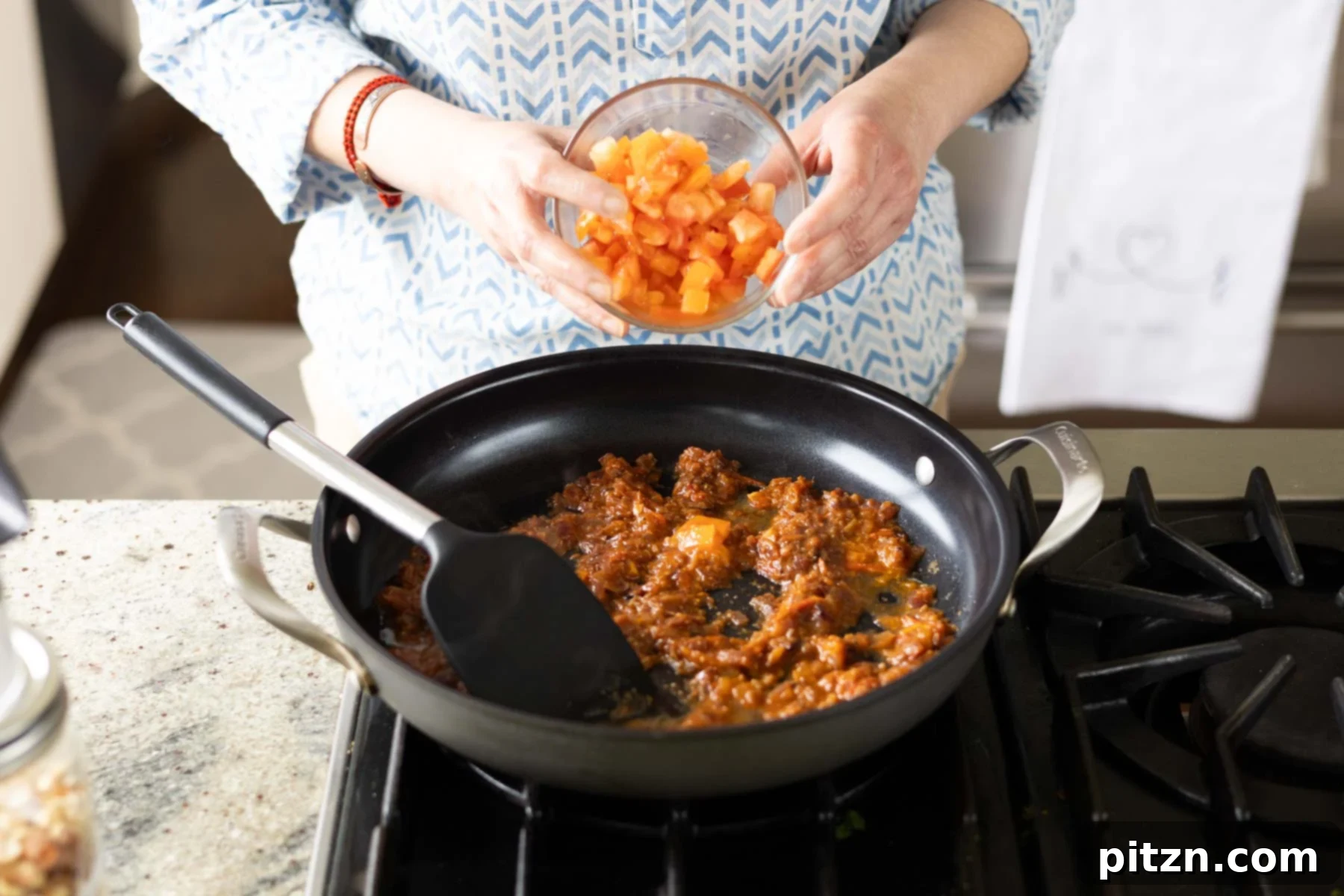 Aromatic Sweet Potato and White Bean Curry Stew 12 adding tomato to the pan