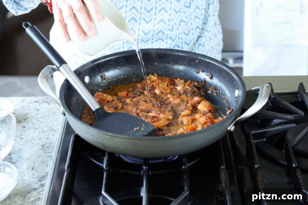 Aromatic Sweet Potato and White Bean Curry Stew 14 adding water to the pan