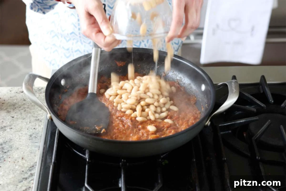 Aromatic Sweet Potato and White Bean Curry Stew 15 adding white beans to the pan