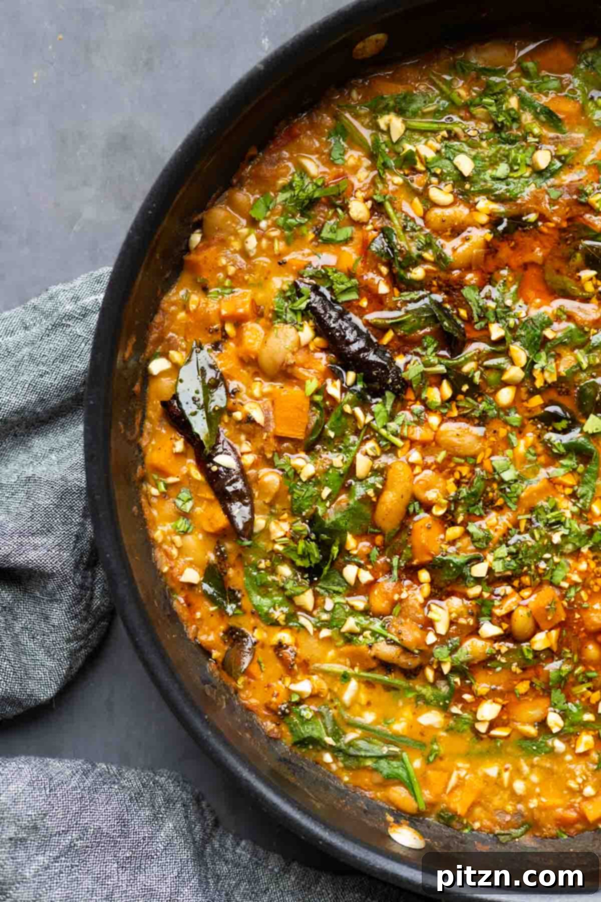 Aromatic Sweet Potato and White Bean Curry Stew 3 close-up of Indian-inspired white bean stew in the pan