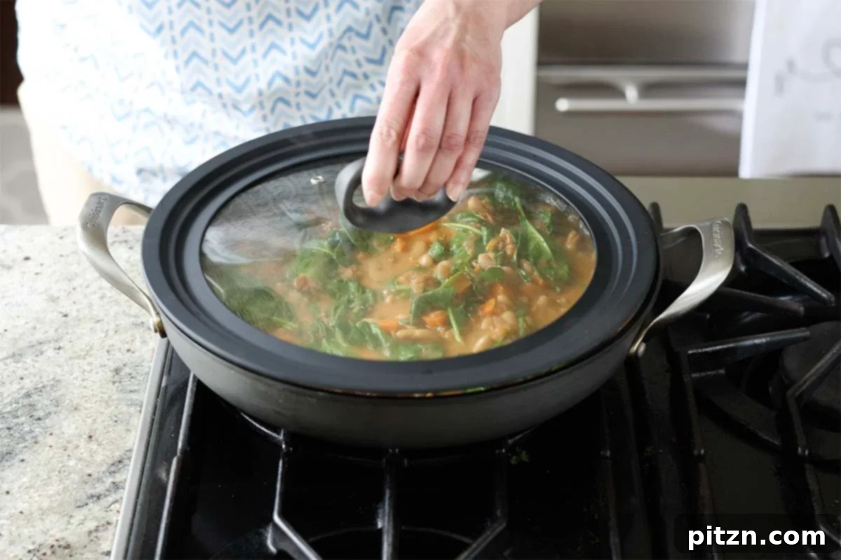 Aromatic Sweet Potato and White Bean Curry Stew 20 covering the pan with the lid