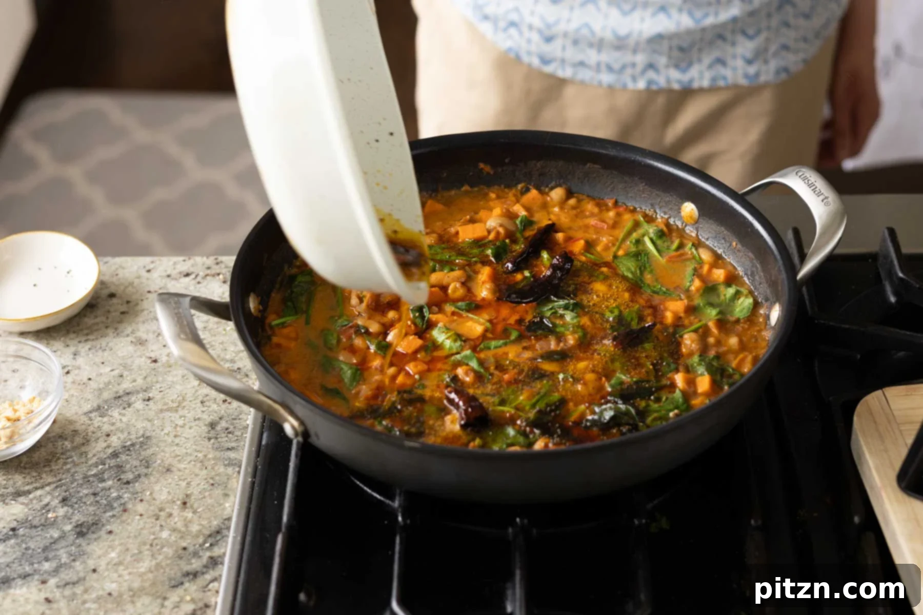 Aromatic Sweet Potato and White Bean Curry Stew 24 adding spiced oil to the Indian-inspired white bean stew