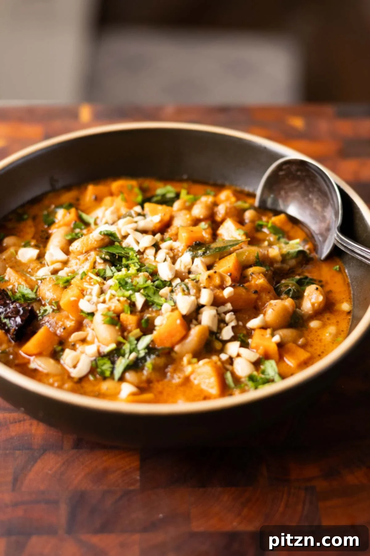 Aromatic Sweet Potato and White Bean Curry Stew 4 close-up of a bowl of Indian bean and sweet potato stew