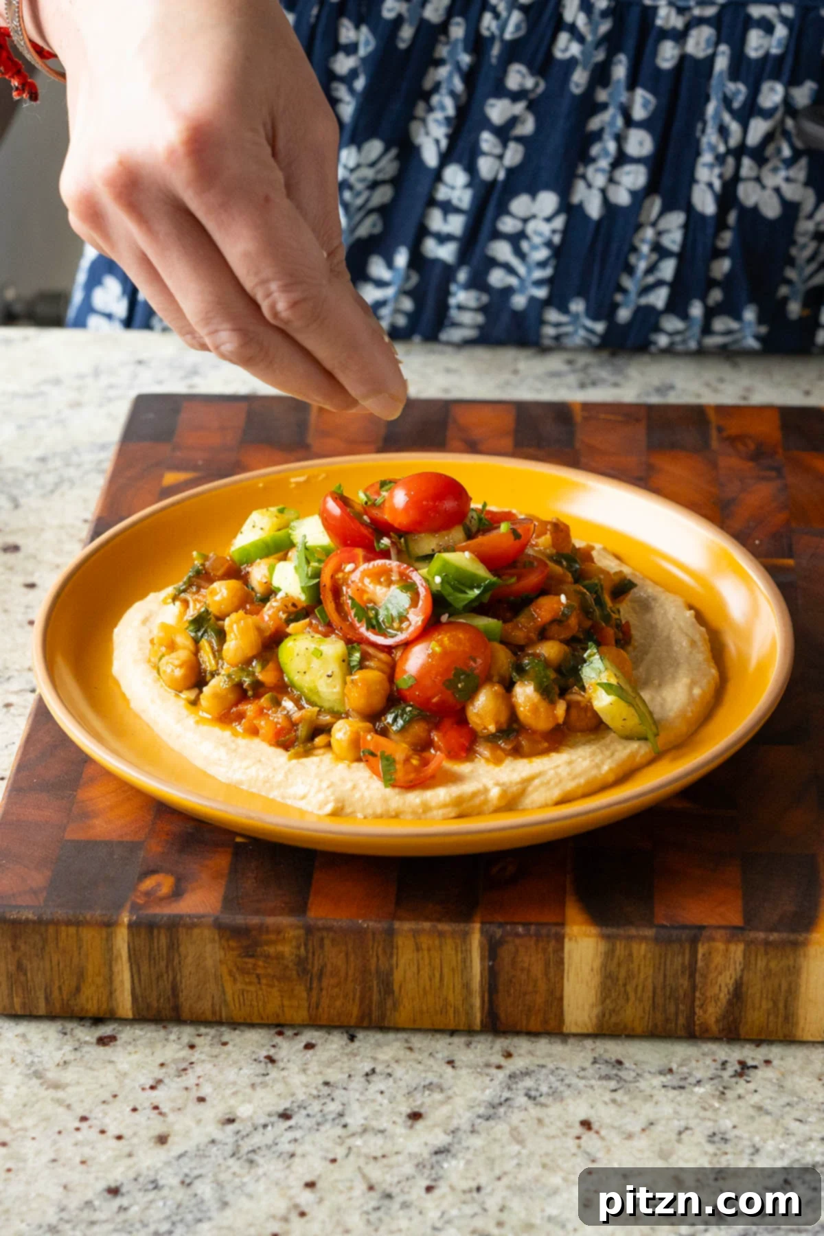 Peri Peri Pan Roasted Chickpeas 3 sprinkling sesame seeds onto the peri peri chickpeas platter