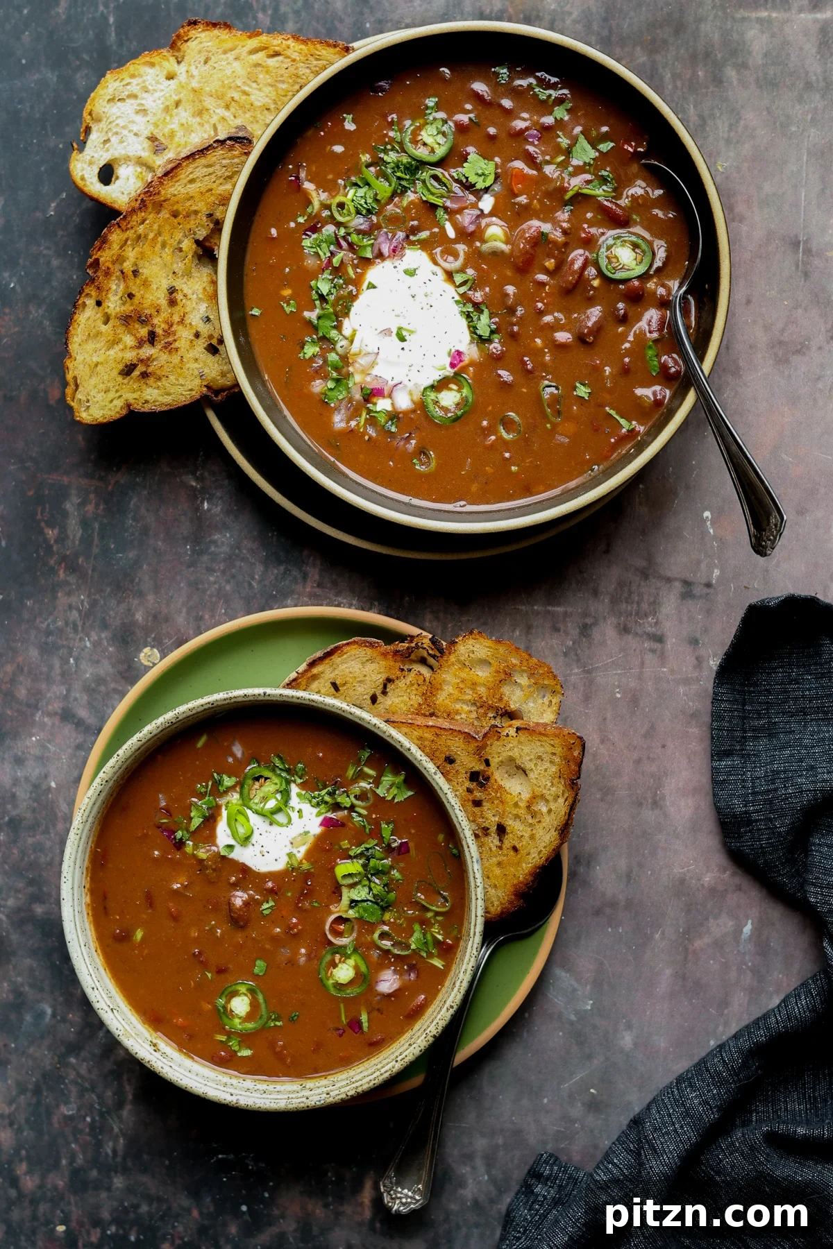 kidney bean chili in bowls with vegan sour cream and other toppings