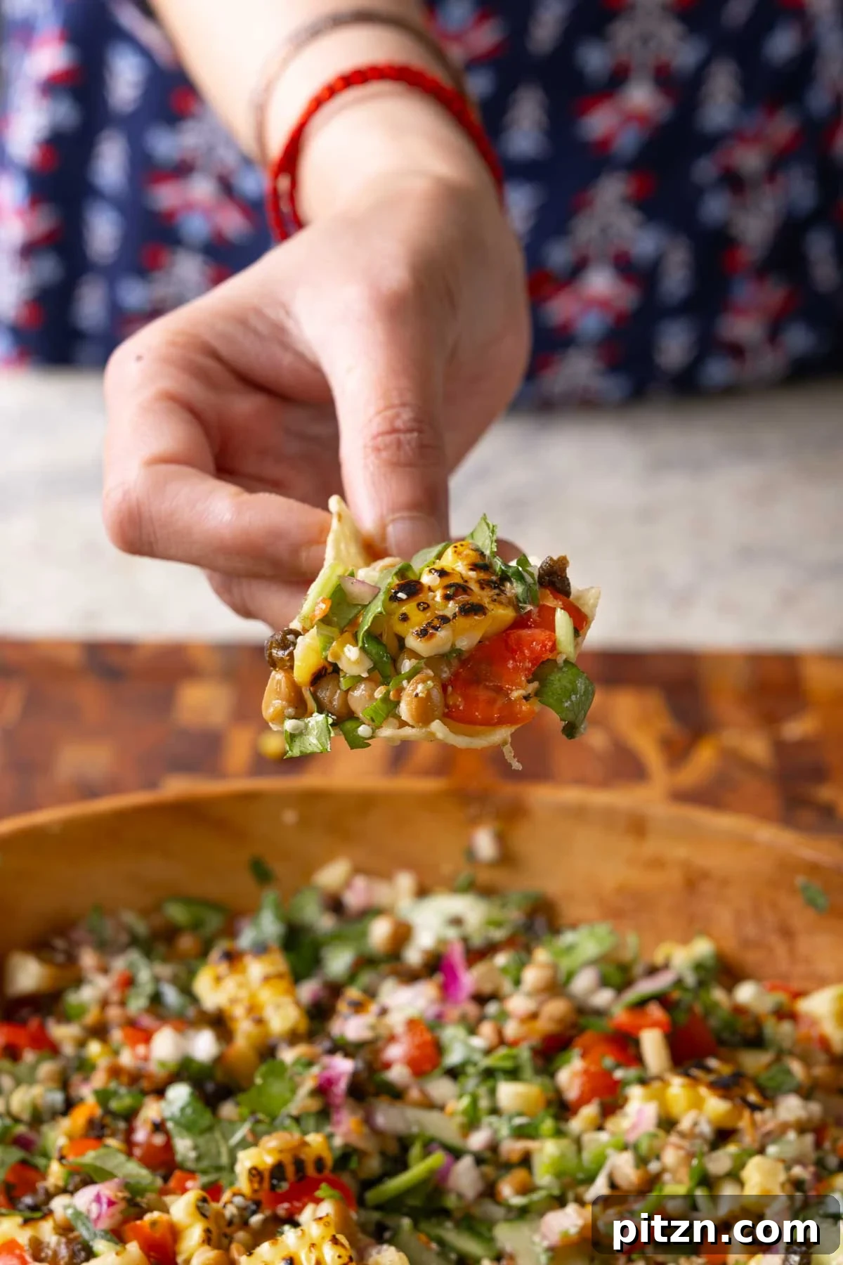 scooping up lentil dip on a tortilla chip