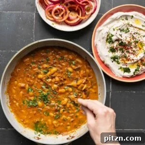 chili garlic beans, onion salad, and whipped tofu in bowls on a black table