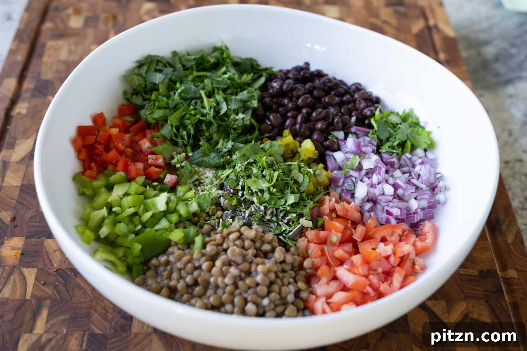 dense bean salad ingredients in the bowl before adding the dressing
