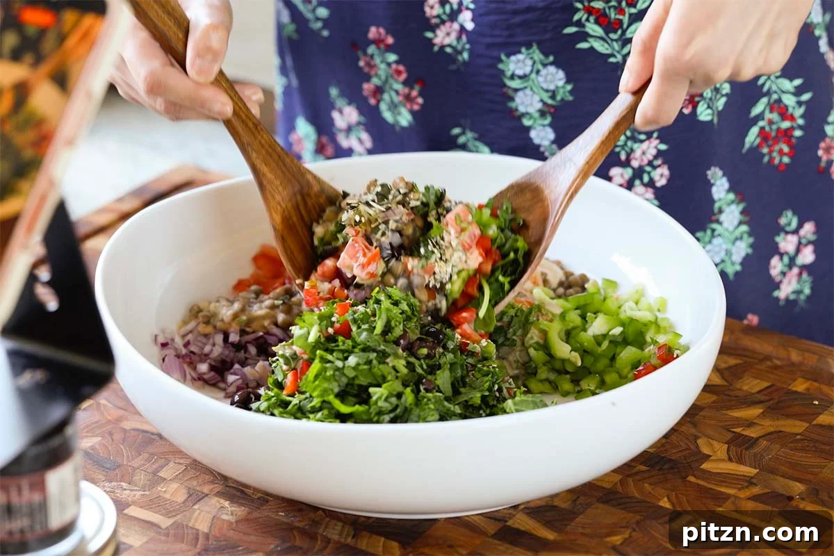 tossing the dense bean salad together