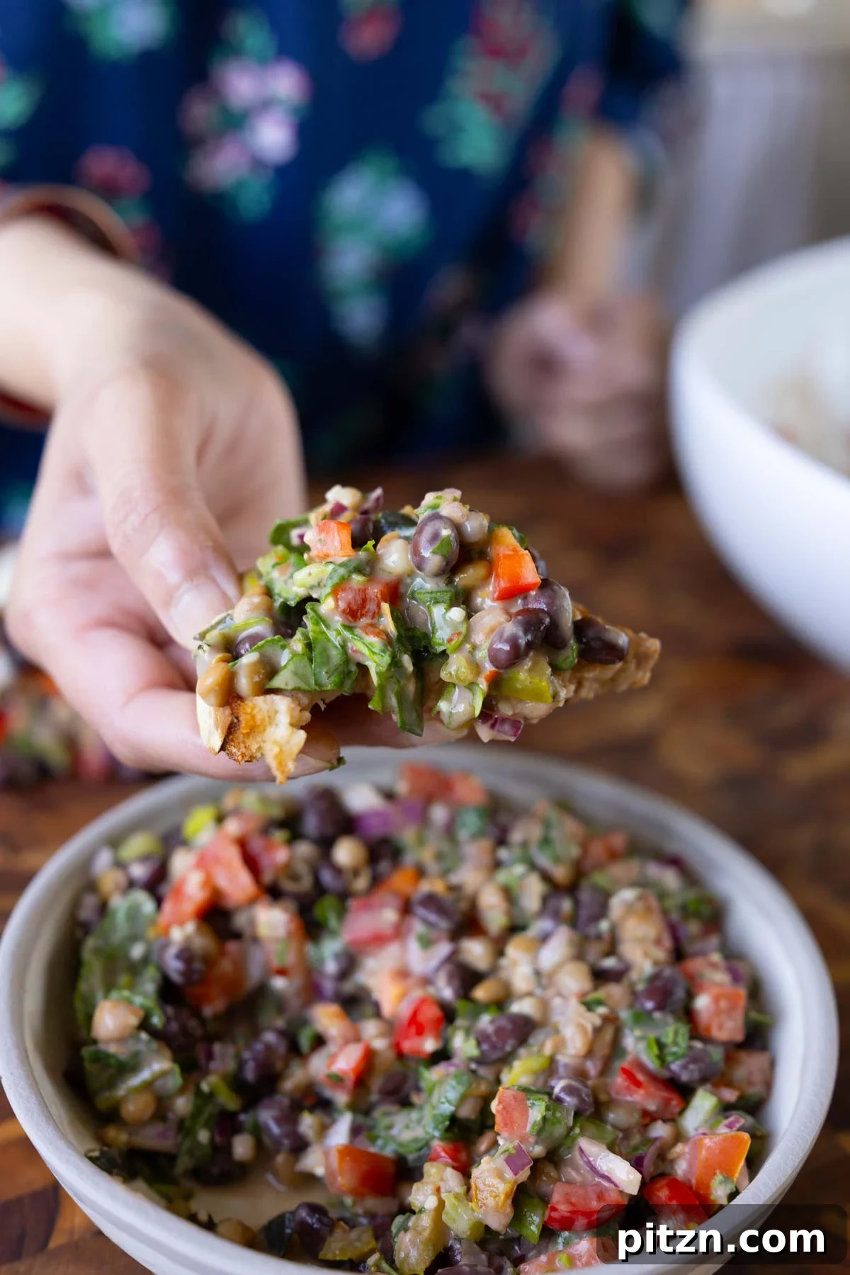 toasted bread scooping up some dense bean salad