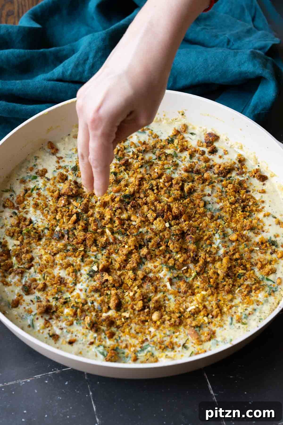 adding the chickpea crumble to the pepper beans