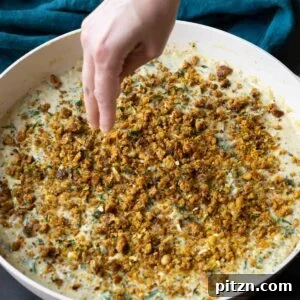 adding the chickpea crumble to the pepper beans